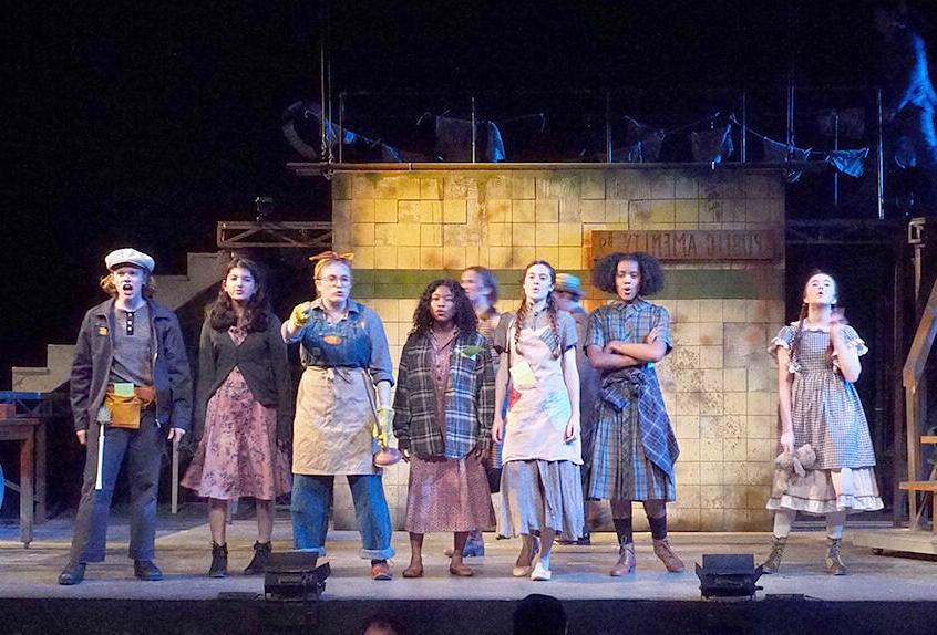 Cast on stage during Upper School musical Urinetown